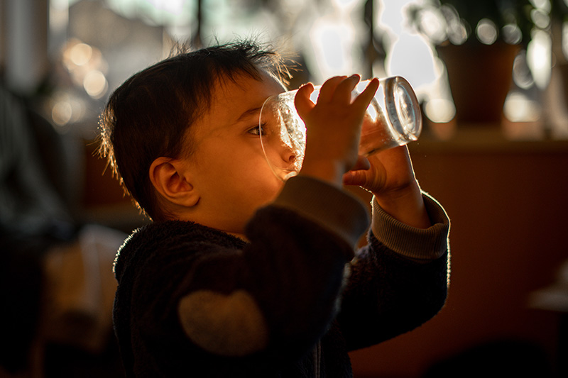 Child drinking clean, pure water free from lead and contaminants